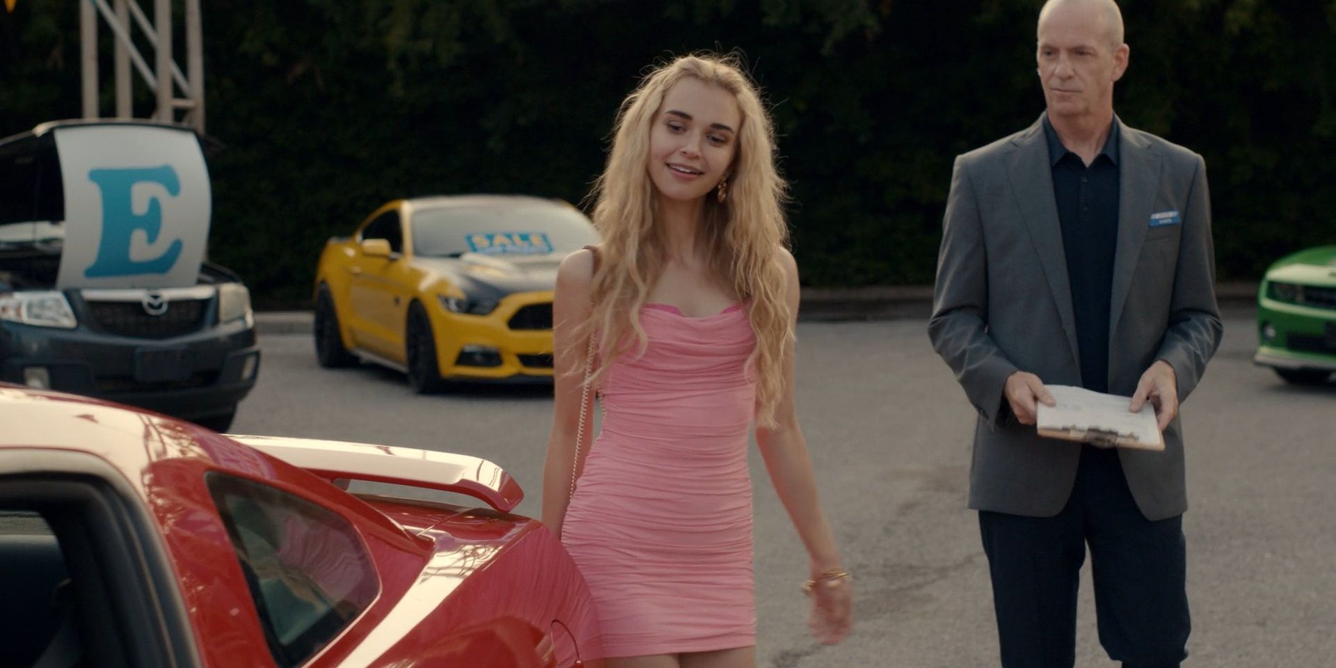 Young Georgia looking at a red car in Ginny & Georgia