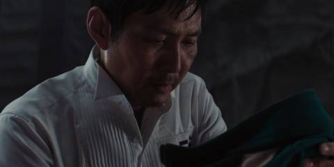 Gi-hun holding Player 222's baby in Squid Game season 3, episode 6