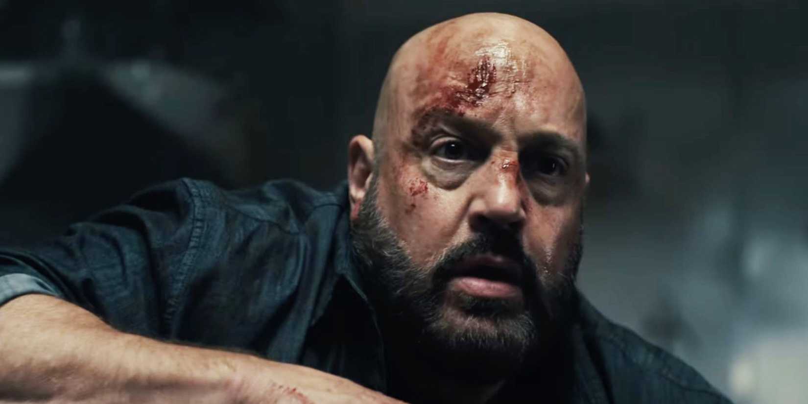 Kevin James looking bloody and scared in Guns Up