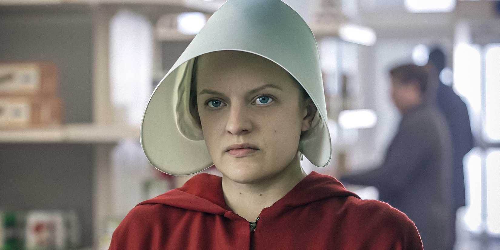 June Osborne (Elisabeth Moss) looking upset, wearing a handmaid's outfit in The Handmaid's Tale.