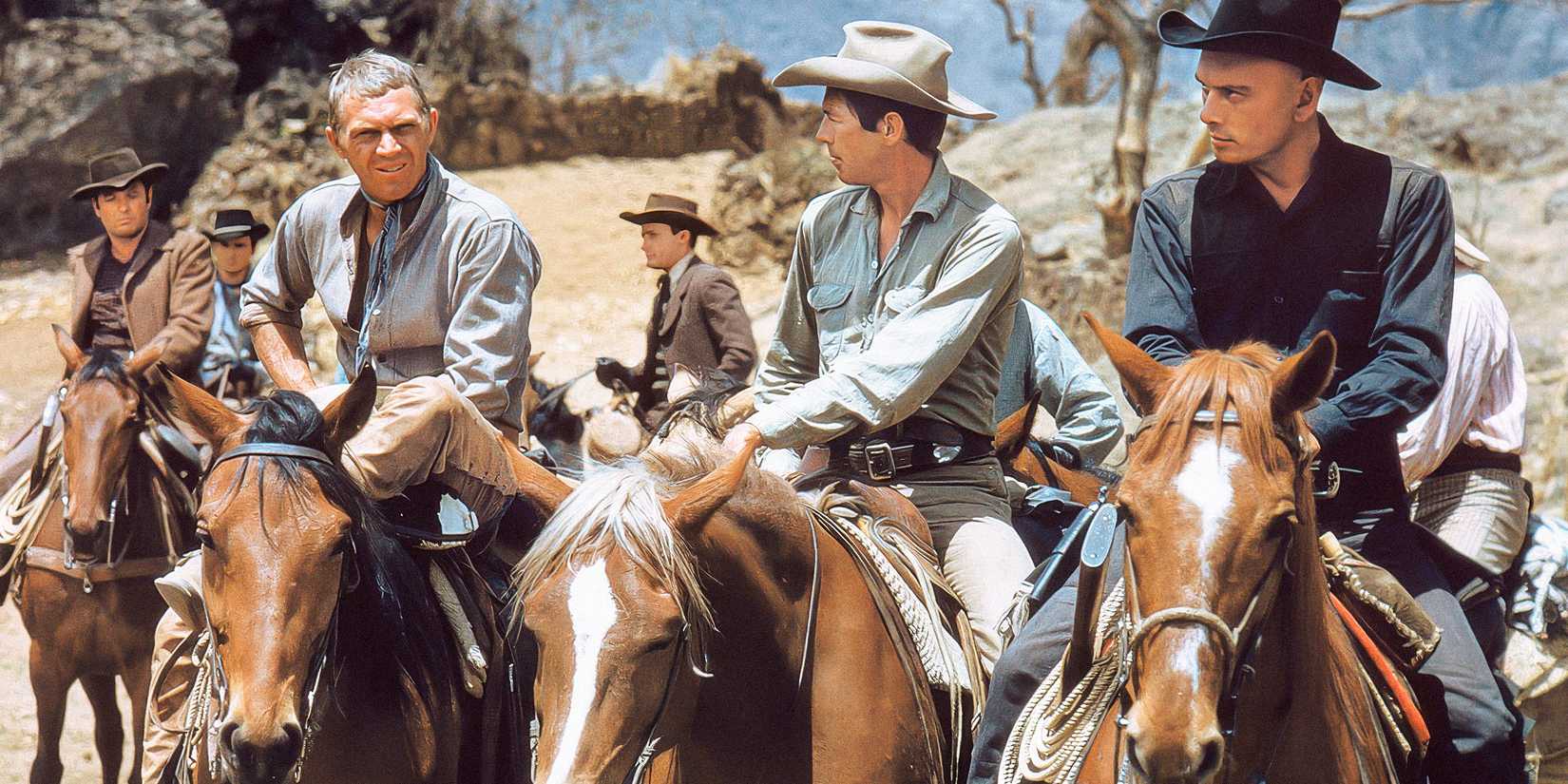 Steve McQueen, James Coburn and Yul Brynner sit on horses in a scene from The Magnificent Seven