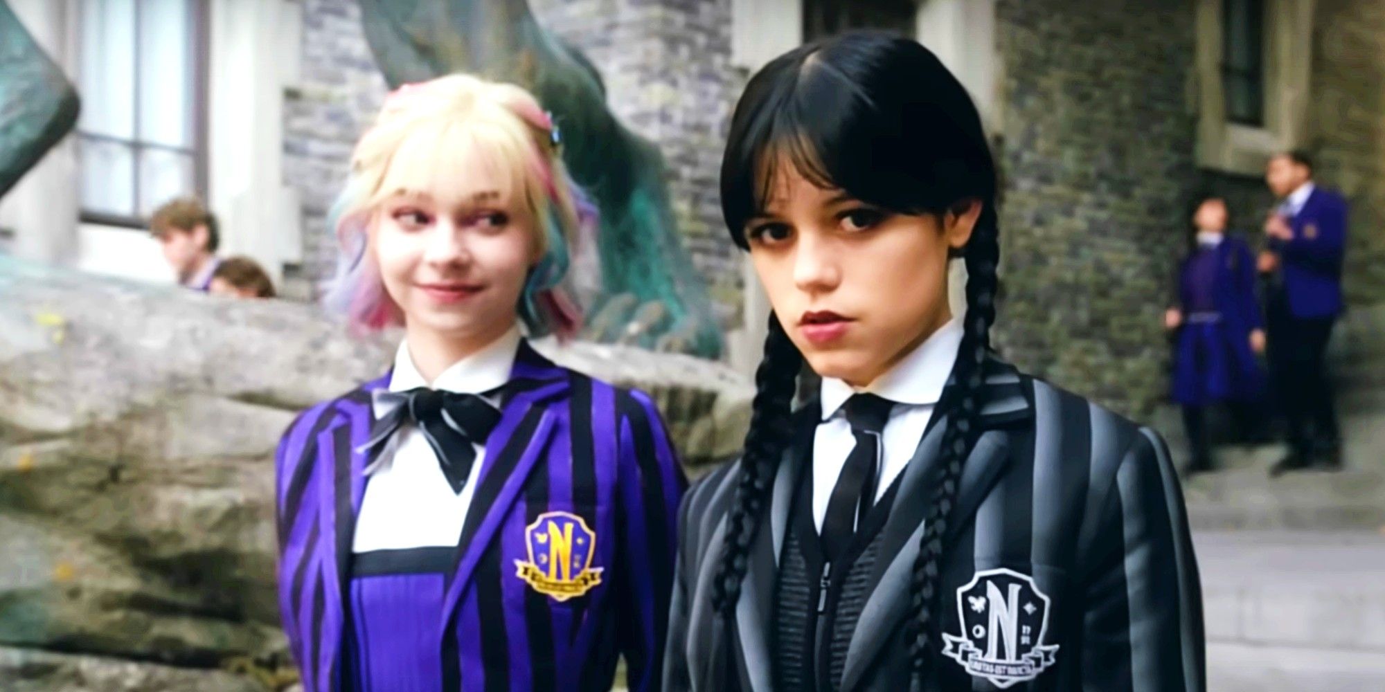 Jenna Ortega as Wednesday Addams looking at the camera and Emma Myers as Enid Sinclair looking at Wednesday in Wednesday season 2 teaser video