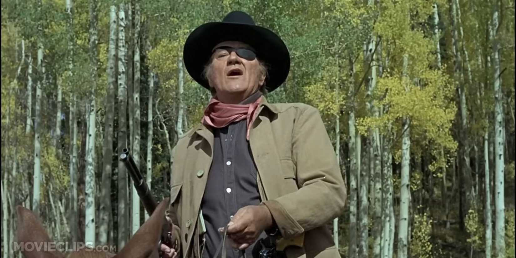 John Wayne as Rooster Coogan on a horse in True Grit