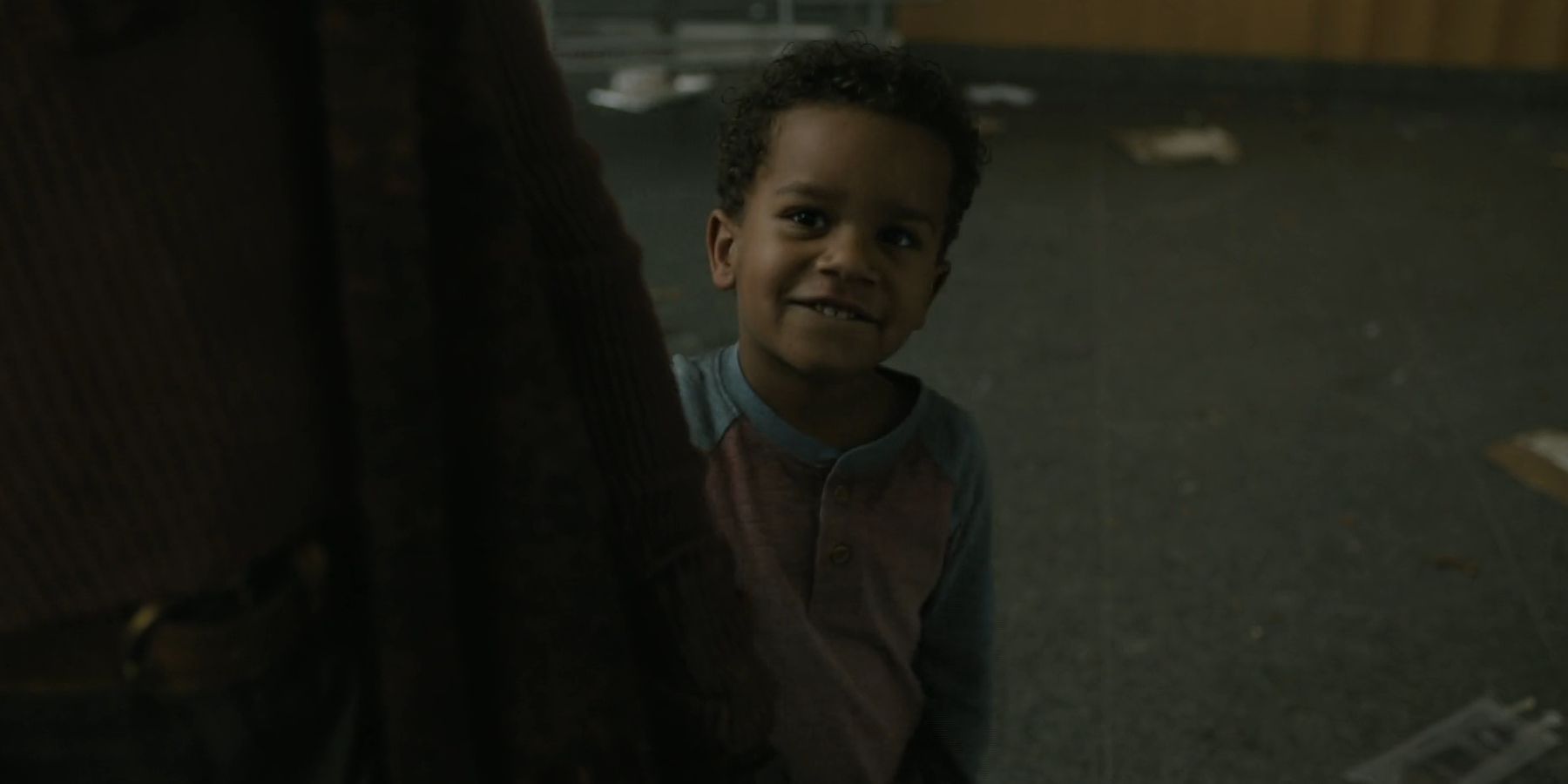 Joshua standing behind Annie and smiling in The Walking Dead: Dead City season 2