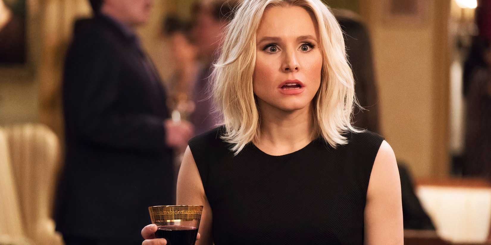Kristen Bell holding a drink and looking shocked in The Good Place