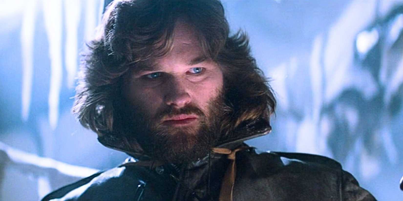 Kurt Russell as Mac holding a lantern in The Thing