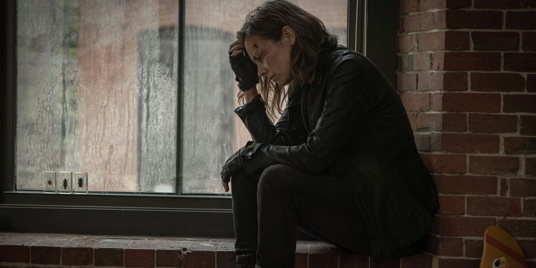 Lauren Cohan as Maggie rubbing her head while looking stressed in The Walking Dead: Dead City season 2