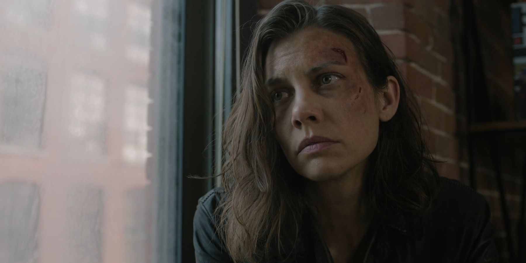 Lauren Cohan as Maggie sitting next to a window in The Walking Dead: Dead City season 2
