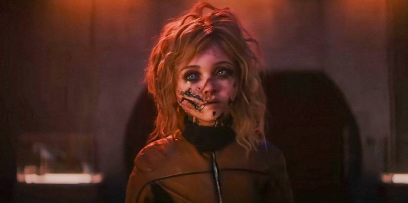 M3gan (Amie Donald) with a ripped up face in M3GAN 2.0
