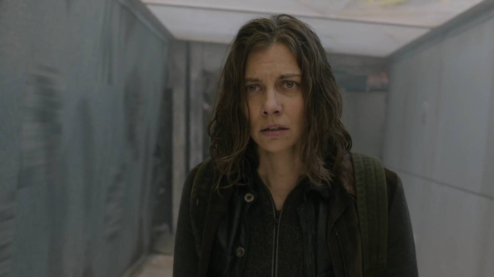 Maggie (Lauren Cohan) looking tired as she crosses a bridge in The Walking Dead: Dead City season 2