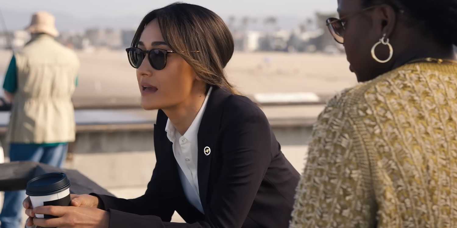Maggie Q's Renée holding a coffee cop and leaning over a railing while talking to Courtney Taylor's Samira Parker in Ballard
