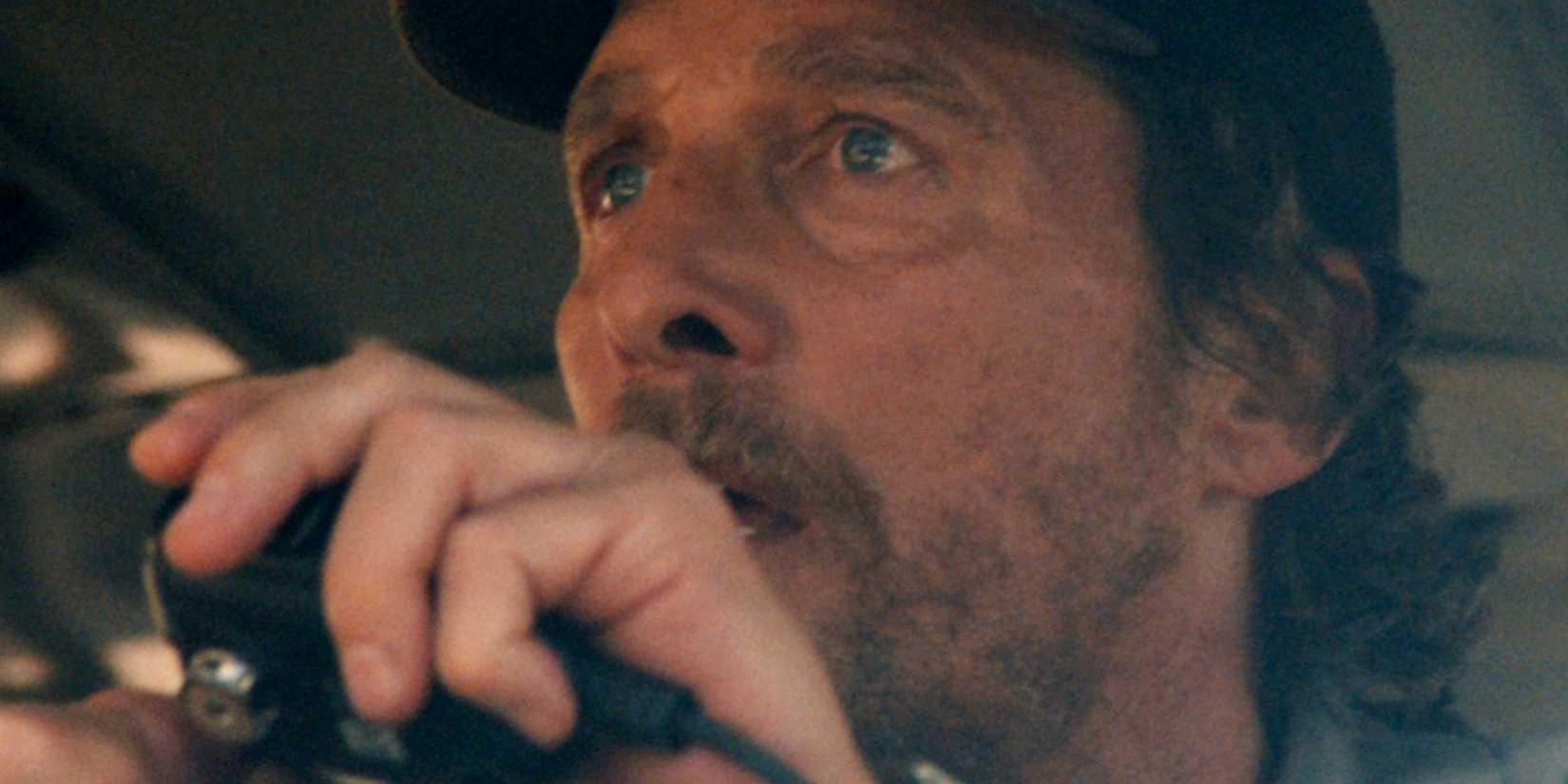 Matthew McConaughey holding up a radio in The Lost Bus