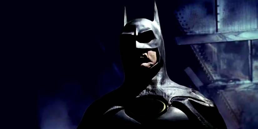 Michael Keaton's Bruce Wayne stands in the shadows wearing his cowl in Tim Burton's Batman Returns