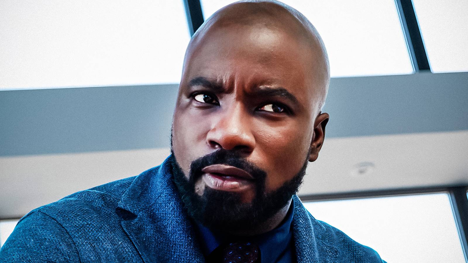 Mike Colter, looking confused, as David in a scene from Evil