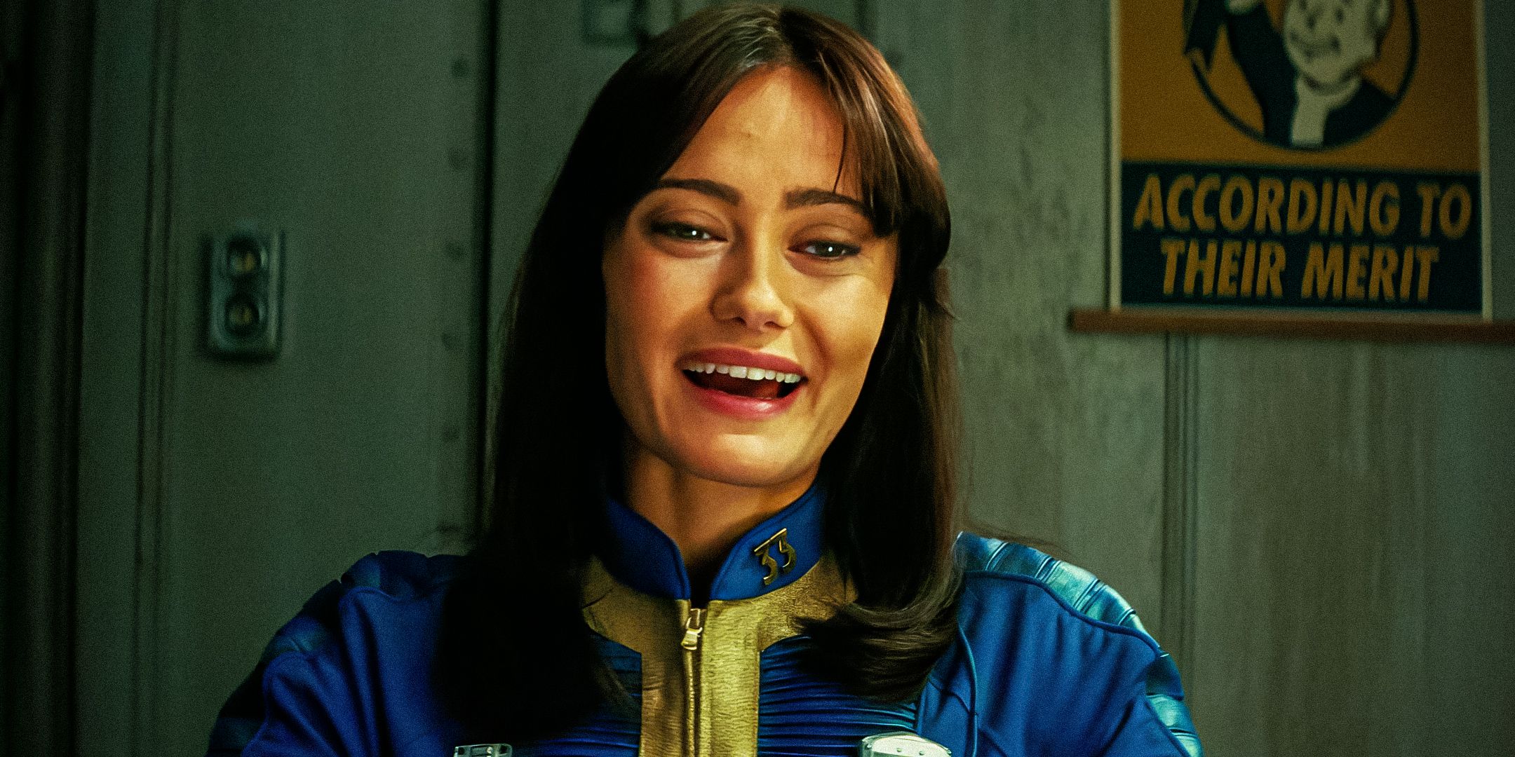 Lucy MacLean (Ella Purnell) laughing in her vault suit in Fallout season 1