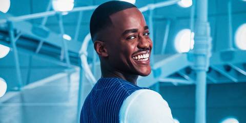 Ncuti Gatwa's Fifteenth Doctor looks over their shoulder smiling in Doctor Who season 15