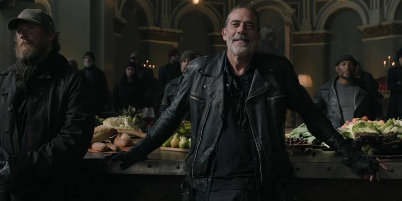 Negan (Jeffrey Dean Morgan) and the Burazi standing in front of a table full of food in The Walking Dead: Dead City season 2