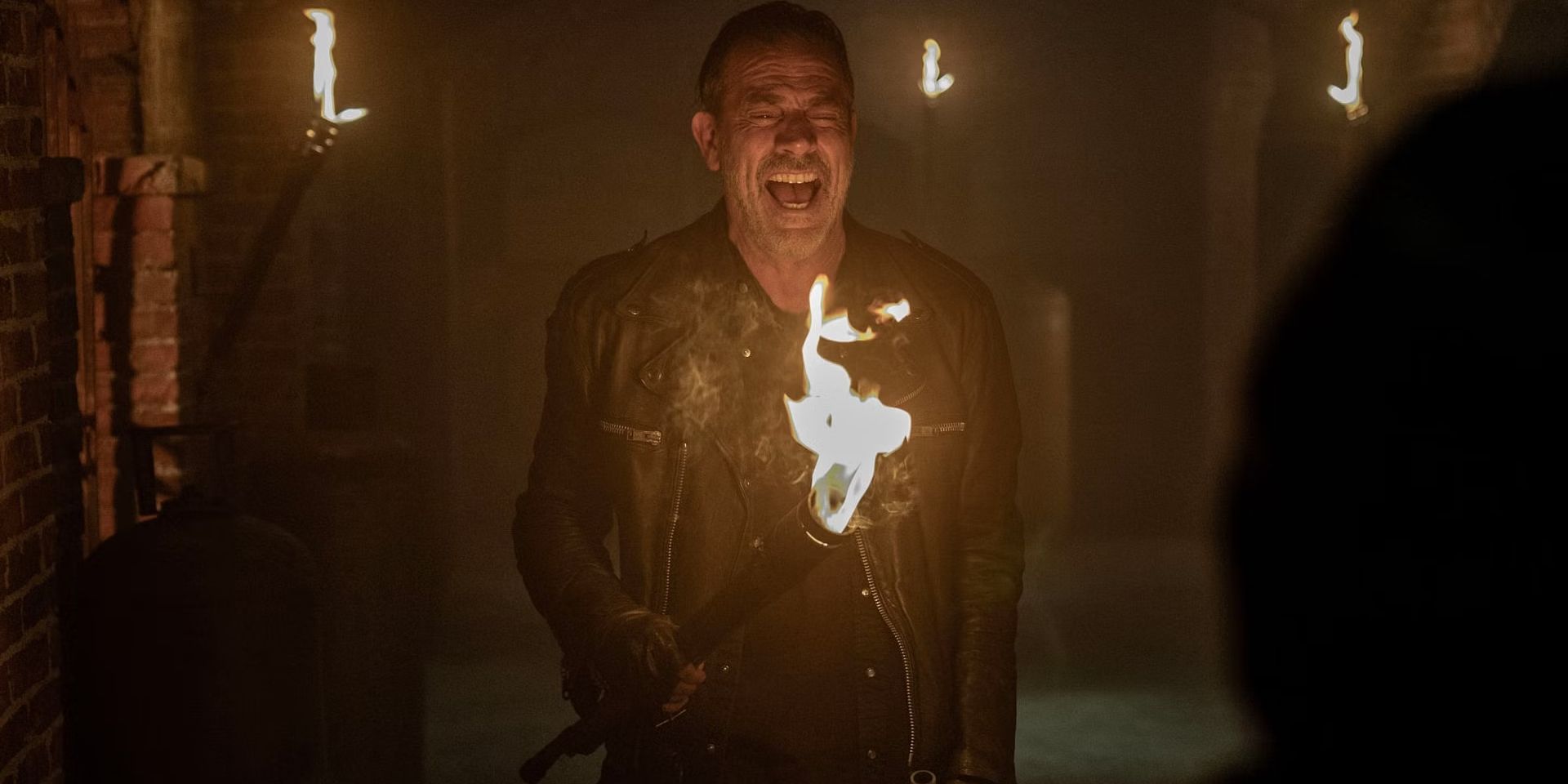 Negan laughing with a torch in The Walking Dead Dead City season 2 finale
