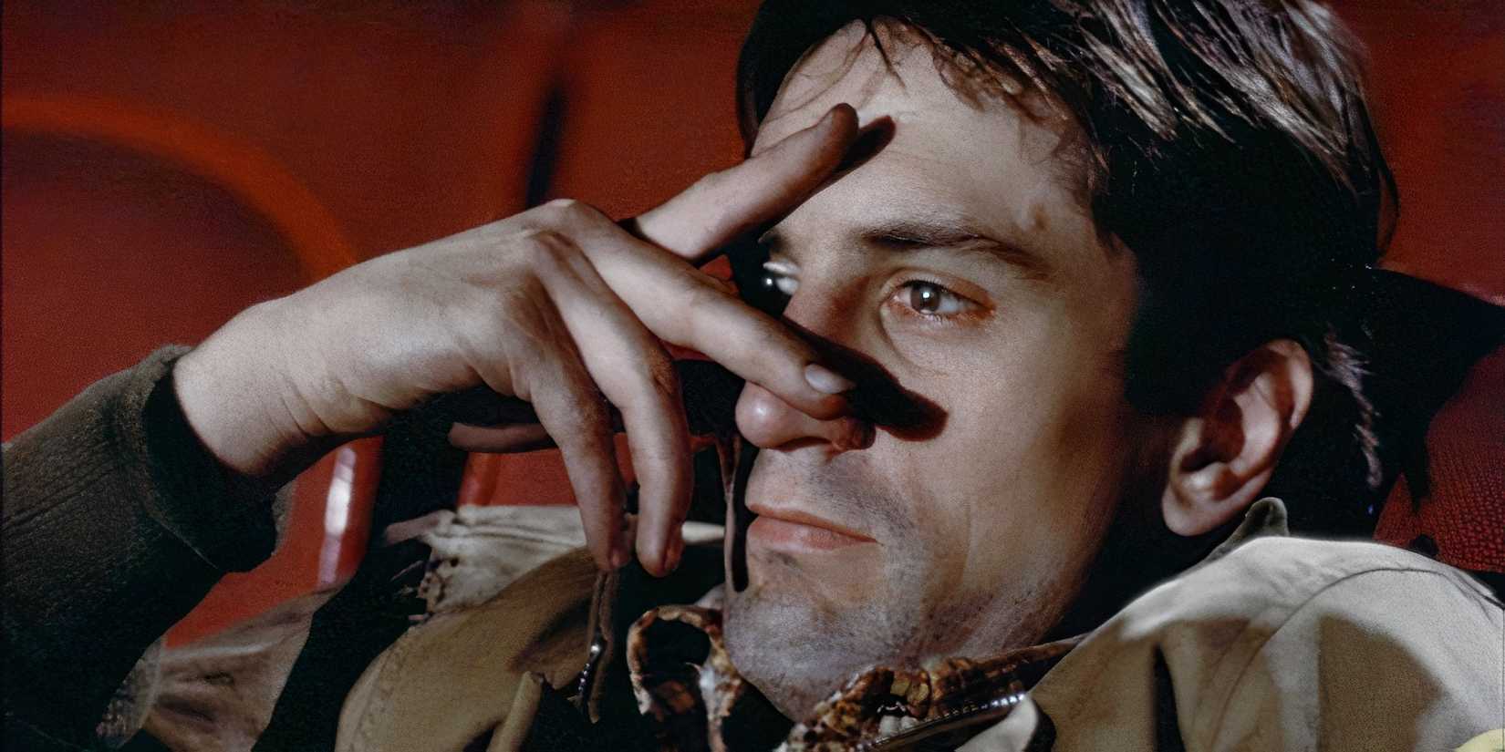 Robert De Niro peers through his fingers at a porn film in a scene from Taxi Driver