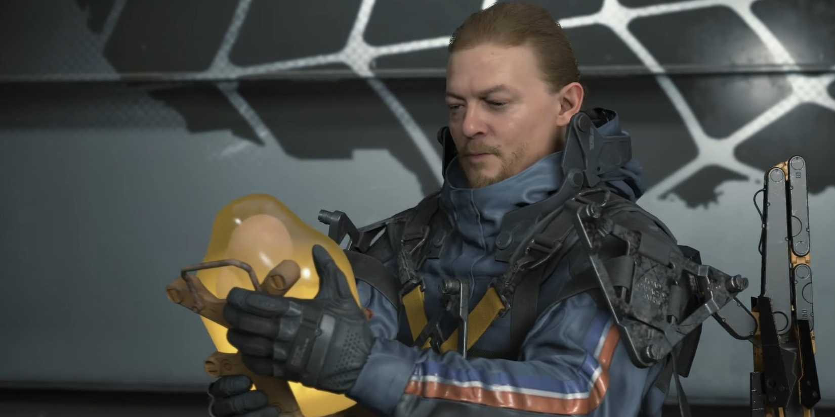Sam holding Lou for one last delivery in Death Stranding.