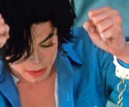 Michael Jackson поднимает руки в наручниках в версии музыкального видео/короткометражного фильма о тюрьме