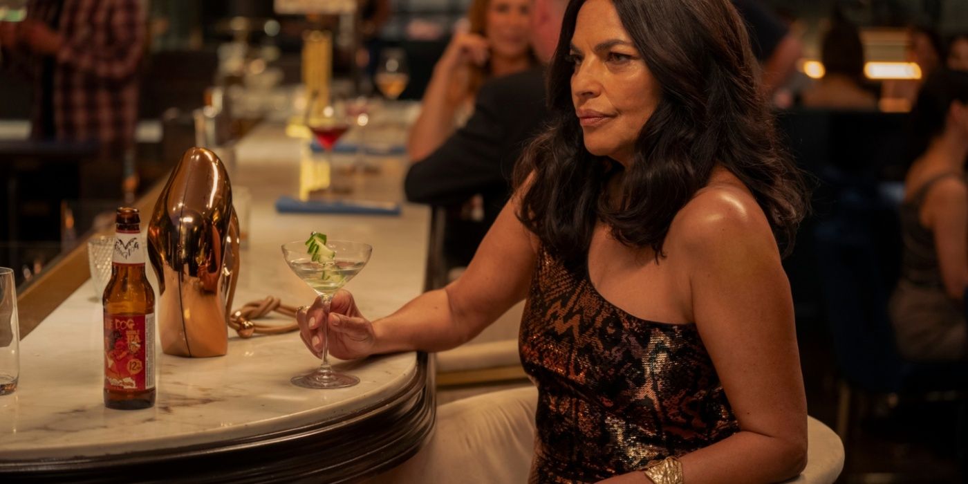 Seema (Sarita Choudhury) sitting at a bar looking annoyed in And Just Like That season 3, episode 2