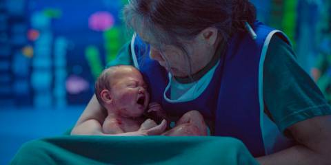 Geum-ja (Kang Ae-sim) receiving the newborn baby in Squid Game Season 3 Ep 2