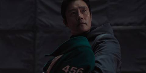 The Front Man holding Player 222's baby in Squid Game season 3, episode 6
