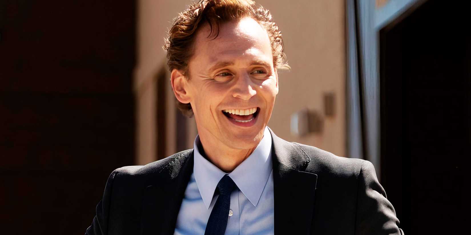 A closeup of Tom Hiddleston as Chuck Krantz smiling in The Life of Chuck