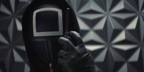 The Masked Officer speaking into a walkie talkie in Squid Game season 2
