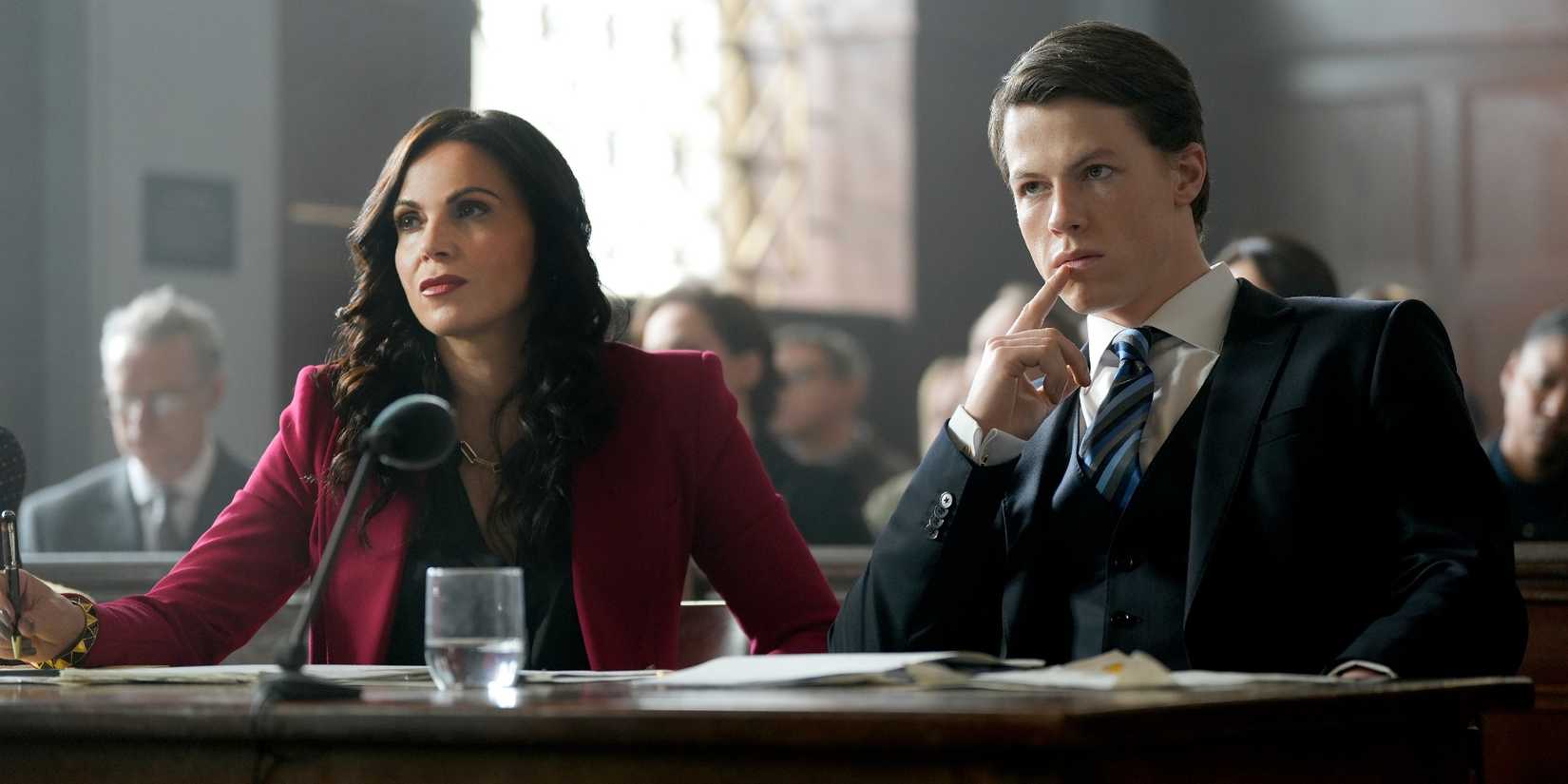 Lana Parrilla and Milo Callaghan sitting in court in USA's The Rainmaker