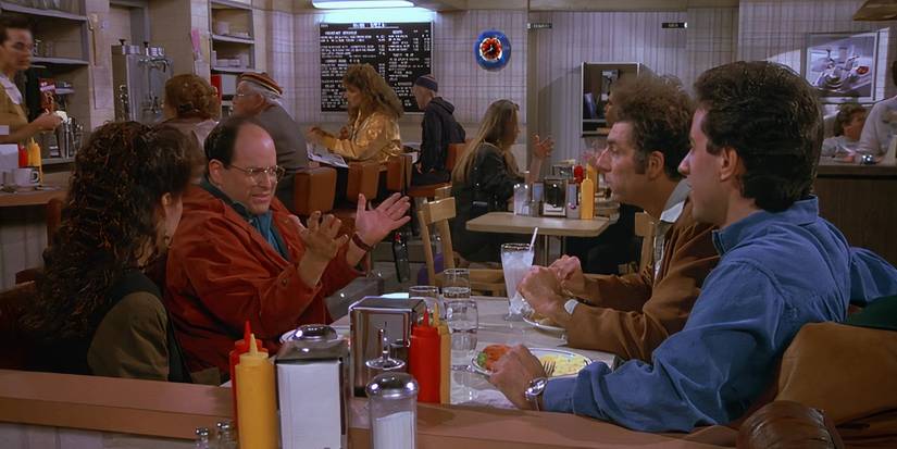 Elaine, Jerry, George e Kramer discutindo enquanto comem no Monk's Café no episódio de Seinfeld "The Contest".