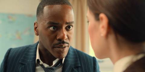 Ncuti Gatwa as the Fifteenth Doctor looking intensely at Anita, whose back is turned to the camera