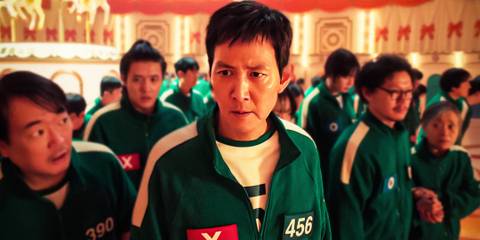 Gi-hun looking worried in a crowd of players during Squid Game season 2