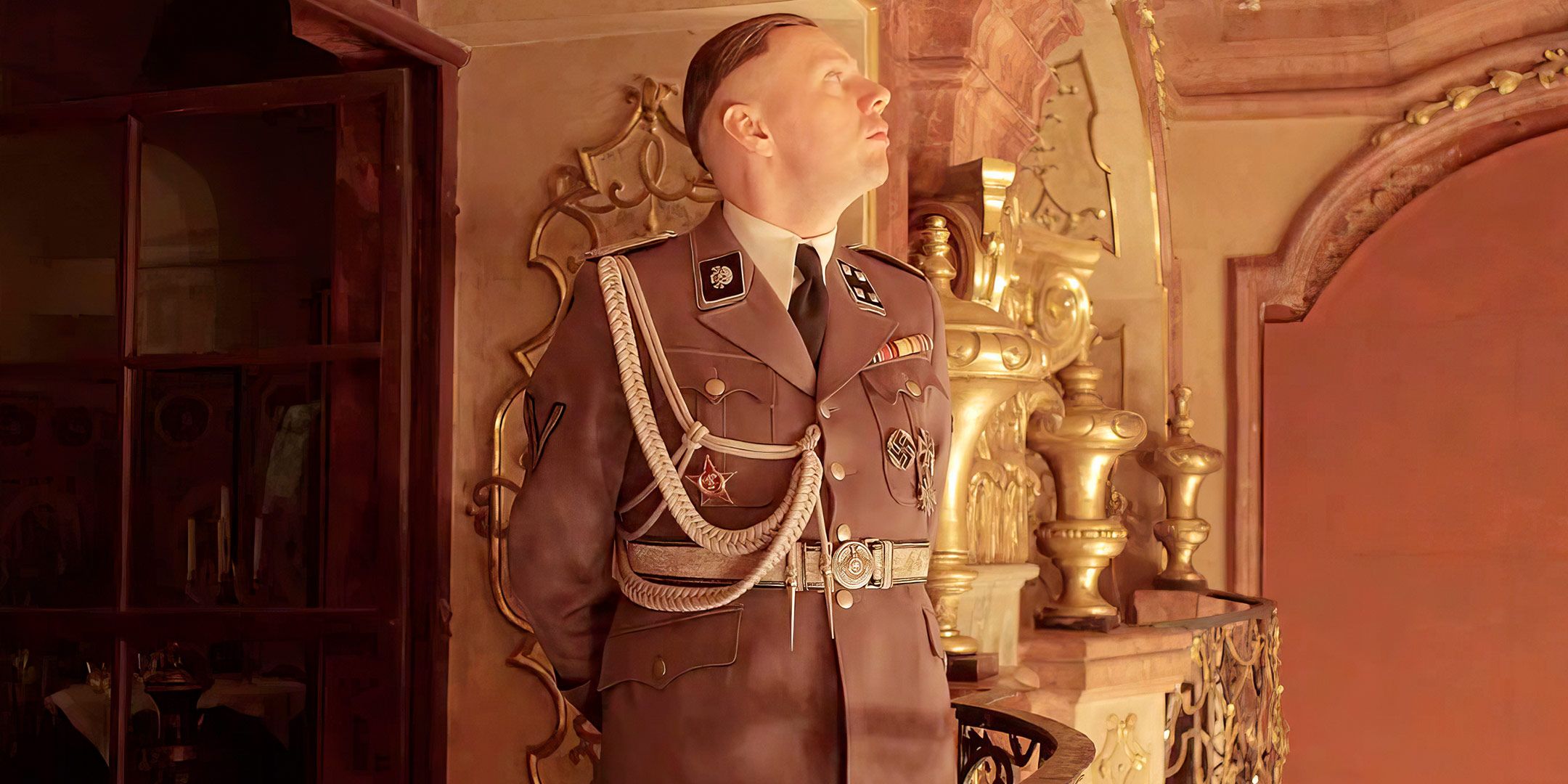 A man in a Nazi uniform looks around inside an opulent room in a scene from Zone of Interest