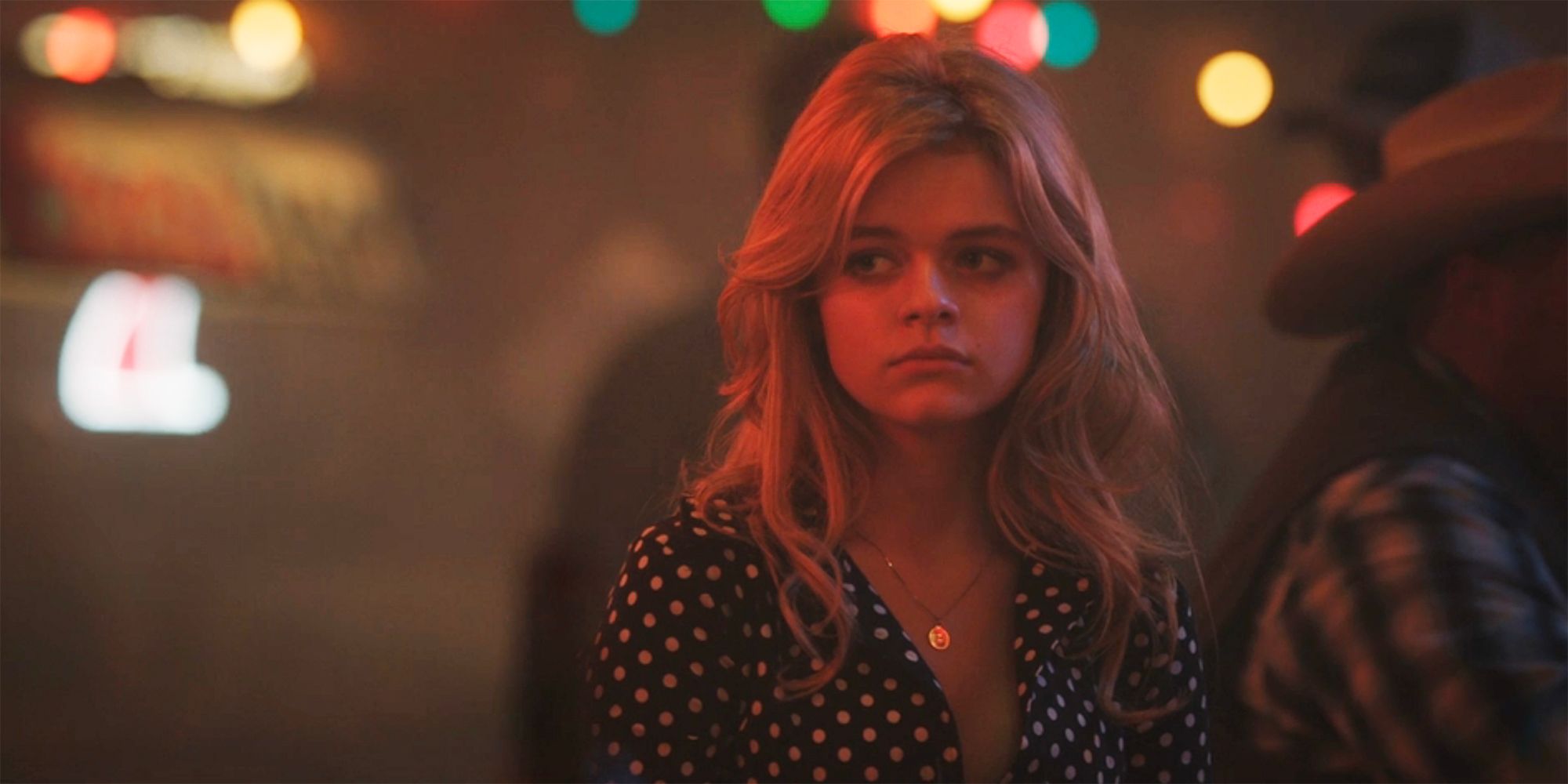Young Beth looks sad at the bar in Yellowstone