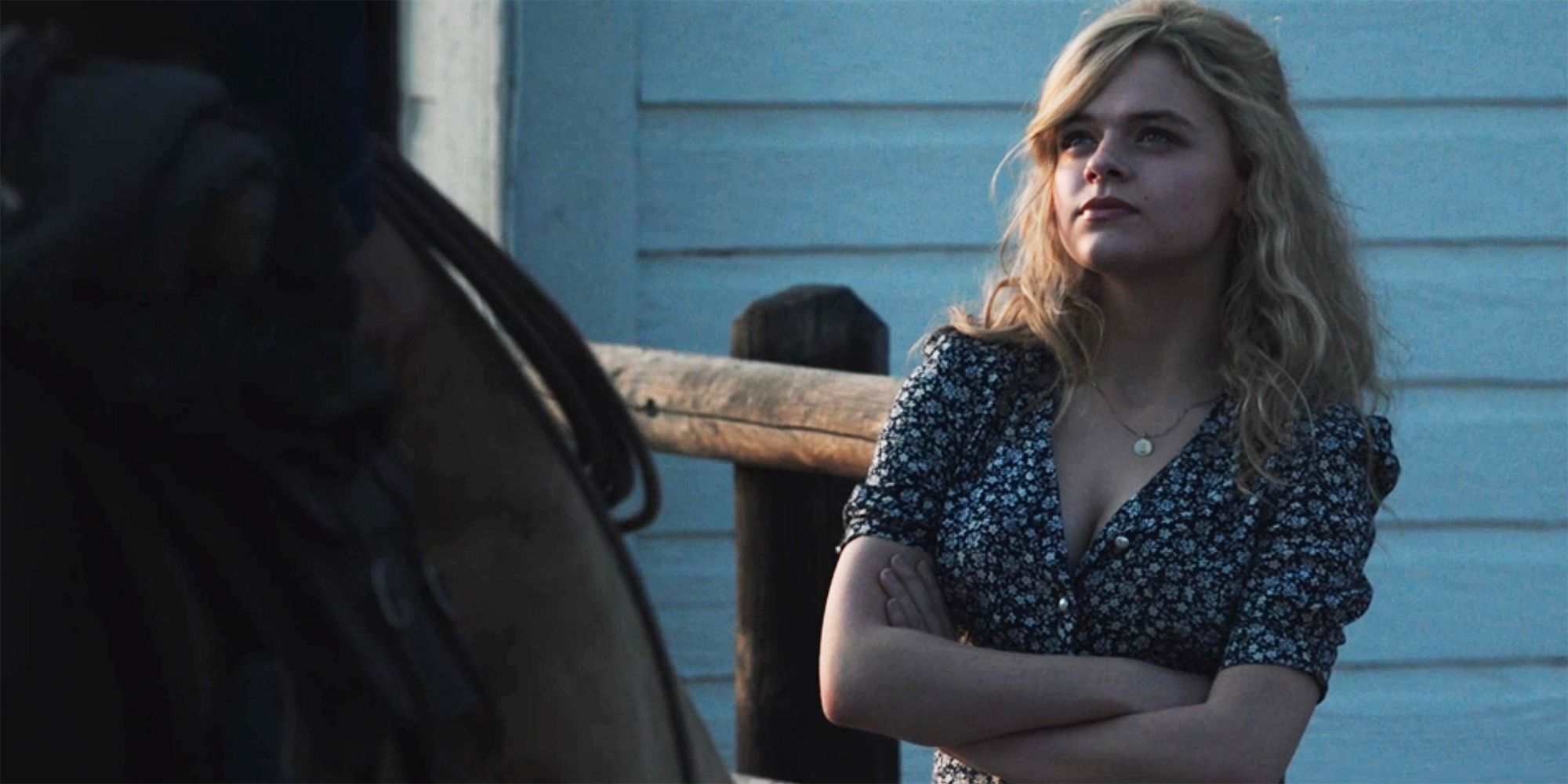 Young Beth looks upward at a cowboy on horseback in Yellowstone