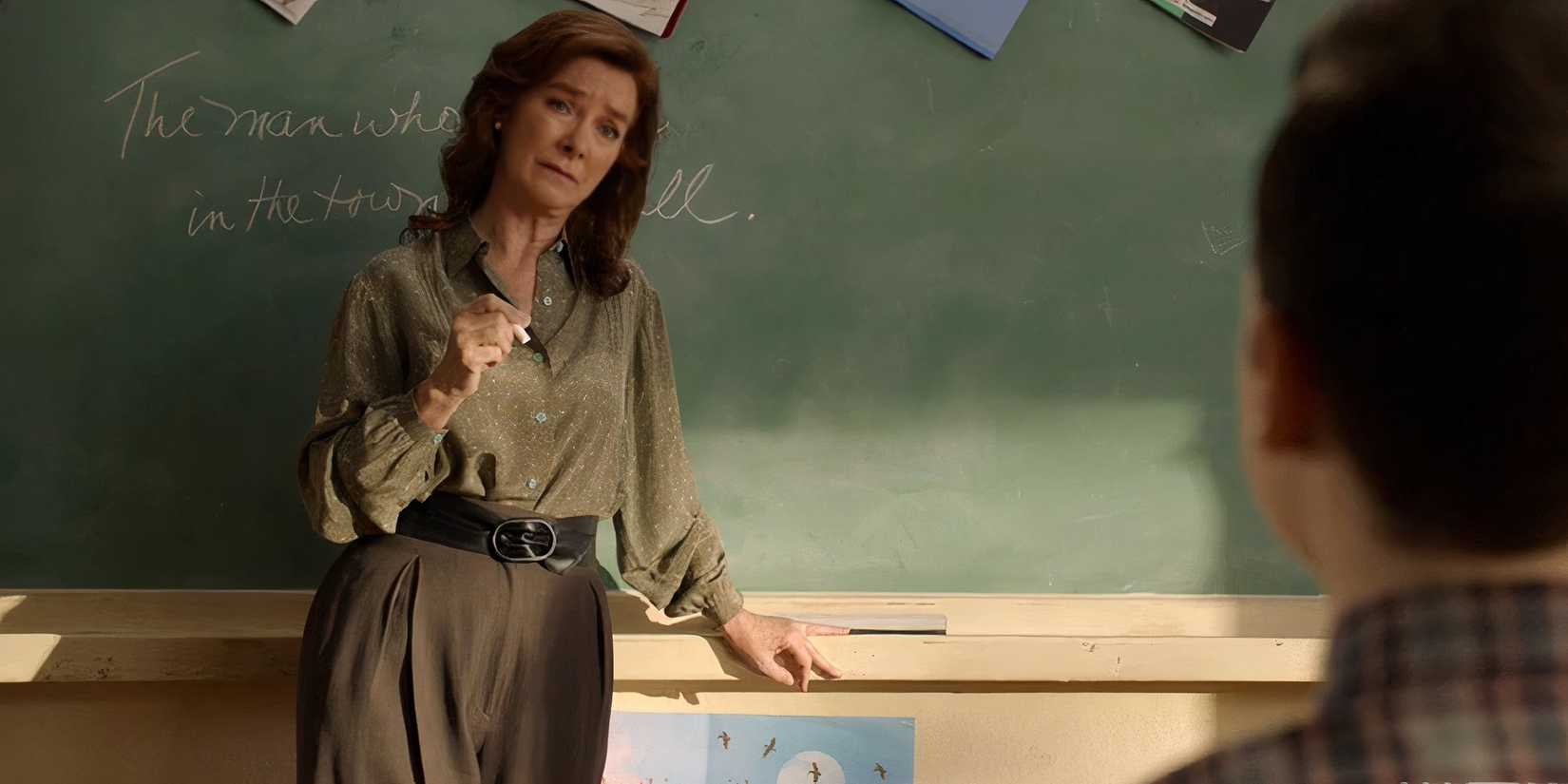 Image of Young Sheldon's Ms.MacElroy in front of a chalkboard