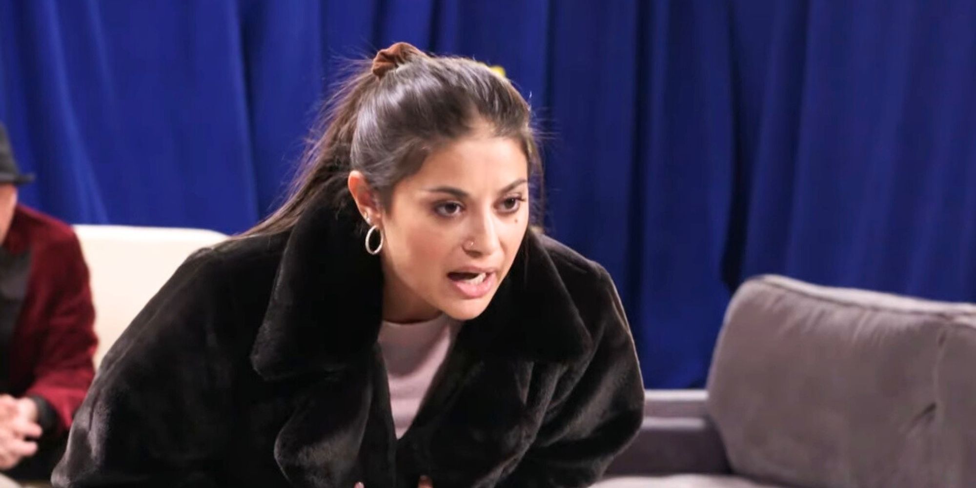 90 Day Fiance's Loren Brovarnik standing up arguing leaning over