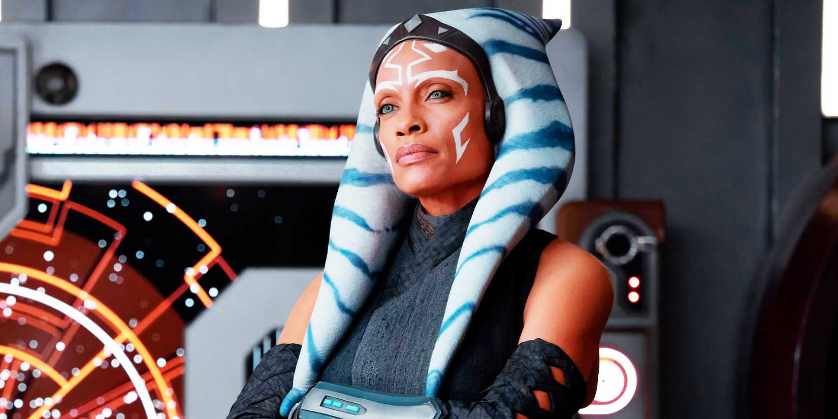 Rosario Dawson as Ahsoka Tano looking serious with her arms crossed in Ahsoka season 1 