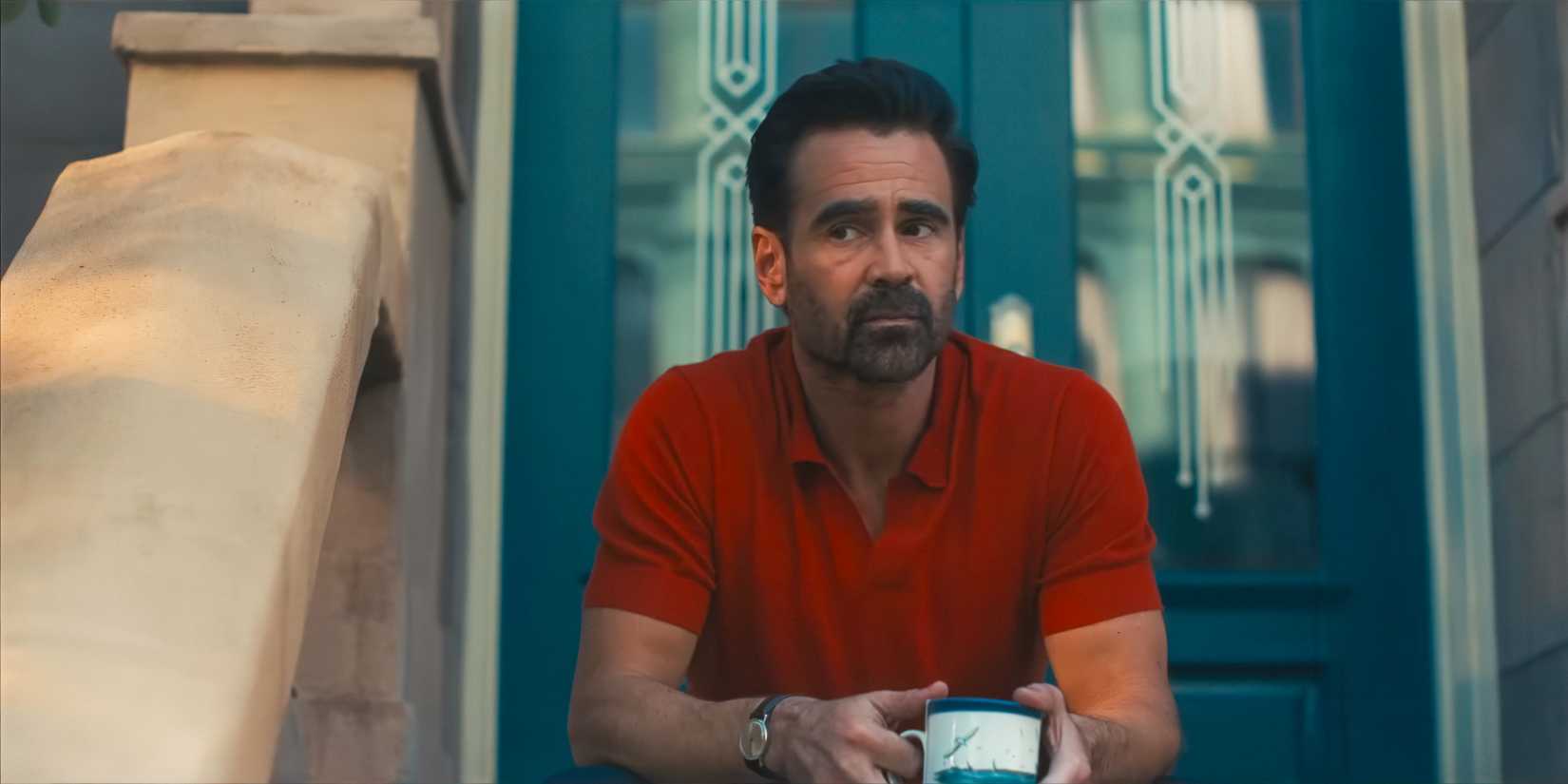 Colin Farrell holding a mug on a porch in A Big Bold Beautiful Journey