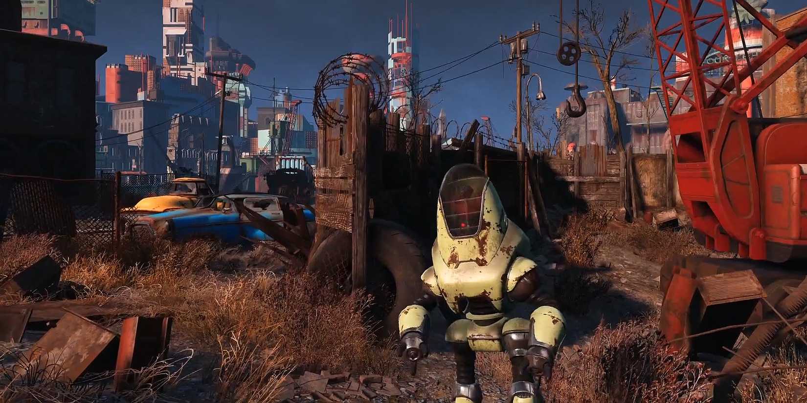 10 Harsh Realities Of Playing Fallout 4 In 2026 5 A Protectron stands in a junkyard from Fallout 4 Official Trailer