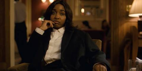 Ayo Edebiri looking bored while wearing a suit in After the Hunt
