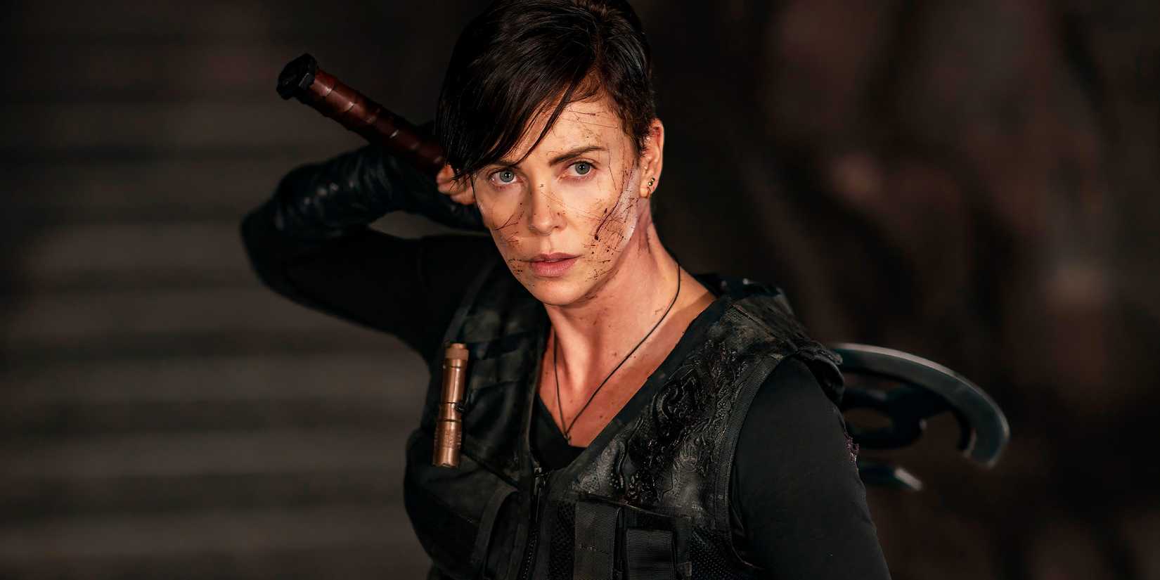 Charlize Theron as Andy with her weapon in The Old Guard.