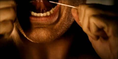 Close-up of Dexter Morgan flossing his teeth in Dexter's opening credits intro