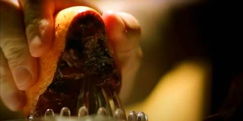 Close-up of Dexter Morgan juicing a blood orange in Dexter's opening credits intro