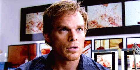 Dexter Morgan looking up surprised with blood spatter behind him in Dexter season 2