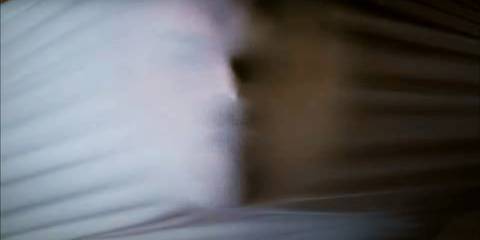 Dexter putting on a white tshirt with his face hidden in Dexter's opening credits intro