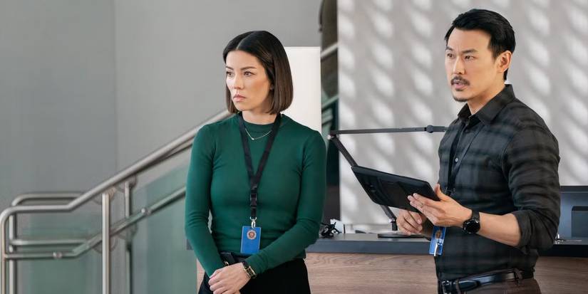 FBI Elise and Ian giving a presentation in front of someone's desk in FBI