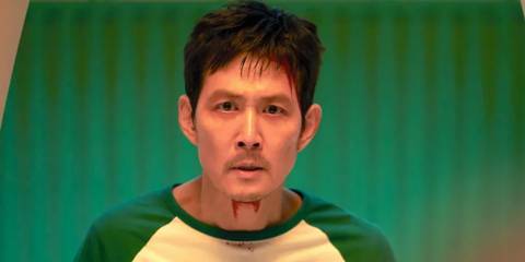 Gi-hun with blood on his neck in Squid Game